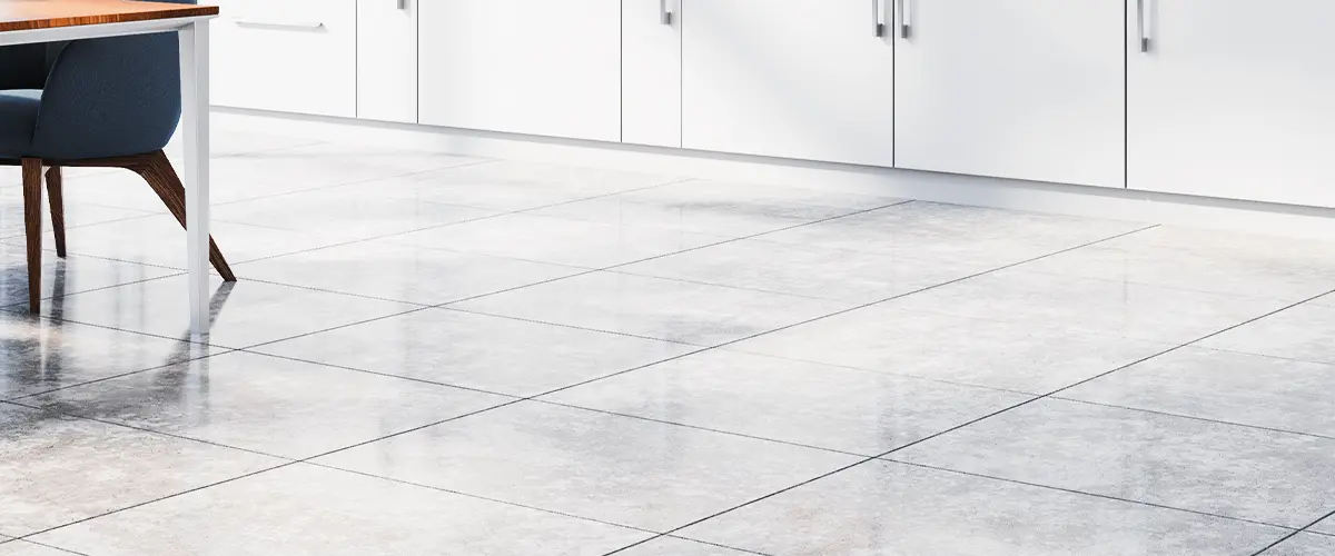 Bright minimalist kitchen with large white floor tiles and panoramic windows