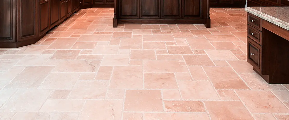 Spacious kitchen with dark wood cabinetry and light beige floor tiles.